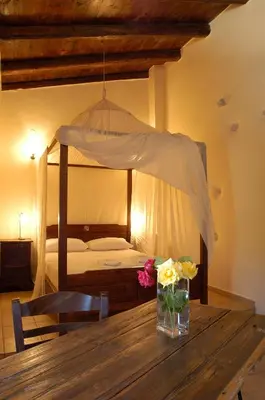 a table with a vase of flowers on top of a bedroom at Elia Hotel & Spa in Áno Voúvai