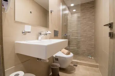 a bathroom with a sink and a toilet at AnDi's Apartment's Paleochora in Palaiochóra