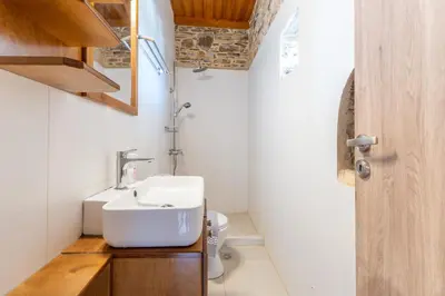 a bathroom with a sink and a toilet at Captain Nikolas in Keramotí