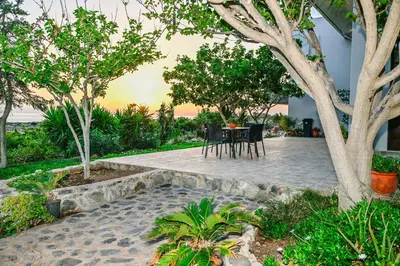 a patio with a table and chairs and trees at Panorama in Elafonisi
