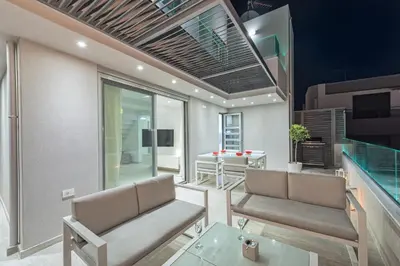 a living room with two chairs and a table at Aenaon Seaview Villa in Plataniás