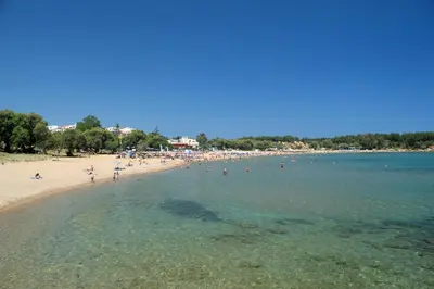 a group of people in the water at a beach at Apartment next to the beach in Kato Daratso