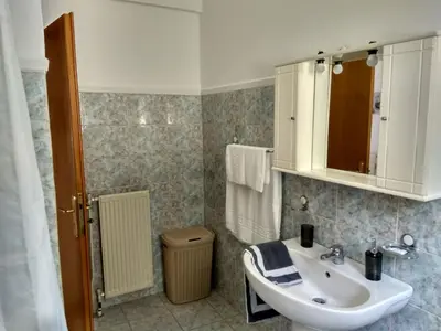 a bathroom with a sink and a toilet at Apartment next to the beach in Kato Daratso