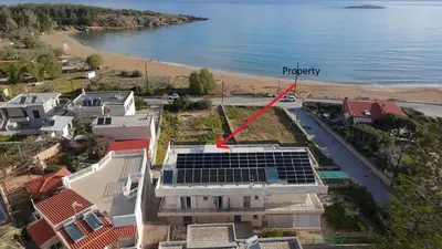 an aerial view of a house with solar panels on the roof at Apartment next to the beach in Kato Daratso