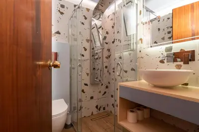 a bathroom with a shower and a toilet and a sink at Niki Rooms in Palaiochóra
