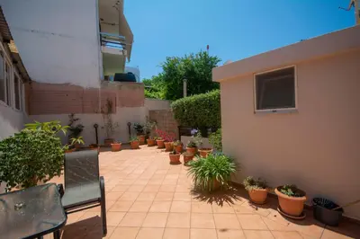 a patio with potted plants and a building at Maria's house in Kissamos