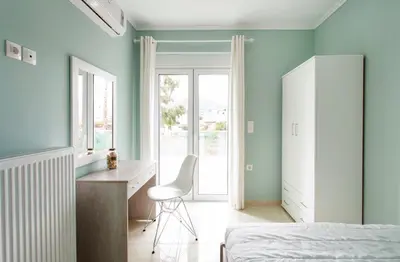 a bedroom with a bed and a desk and a chair at Villa Despina in Kisamos in Kissamos