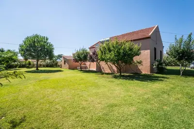 an empty yard next to a building with trees at Villa Filoxenia 1937 in Gerani Chanion