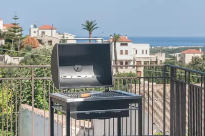 a computer monitor and keyboard on a table on a balcony at Apithano Heated pool on demand in Spiliá