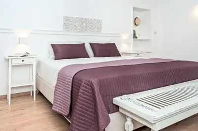 a bedroom with a large bed and a table at Apithano Heated pool on demand in Spiliá