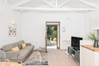 a living room with a couch and a table at Apithano Heated pool on demand in Spiliá