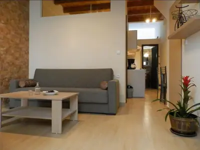 a living room with a couch and a coffee table at Agora Apartments Ground Floor in Kissamos