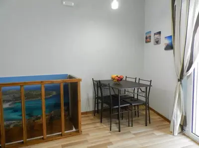 a dining room with a table and chairs in a room at Agora Apartment First Floor in Kissamos