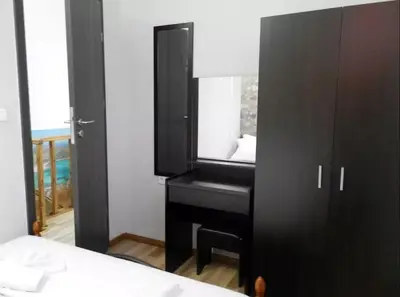 a bedroom with a mirror next to a bed at Agora Apartment First Floor in Kissamos