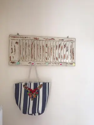 a shelf with a purse hanging on a wall at Christina Apartment in Kissamos