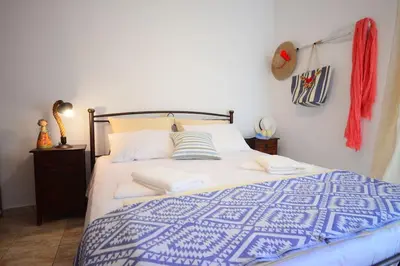 a bedroom with a blue and white bed with towels at Christina Apartment in Kissamos