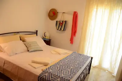 a bedroom with a large bed with a window at Christina Apartment in Kissamos