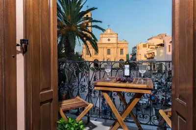 a balcony with a table and glasses of wine at Casa Irene in Chania Town