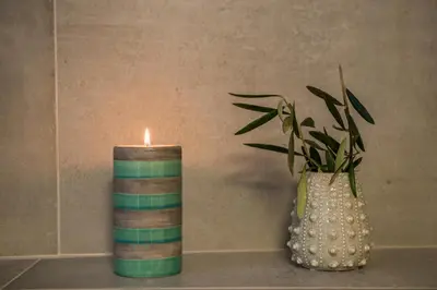 a candle sitting next to a vase with a plant at Casa Irene in Chania Town