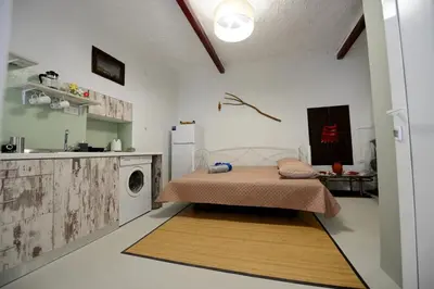 a bedroom with a bed and a washing machine at Traditional Cretan Country House (9klm from Elafonissi) in Plokamianá
