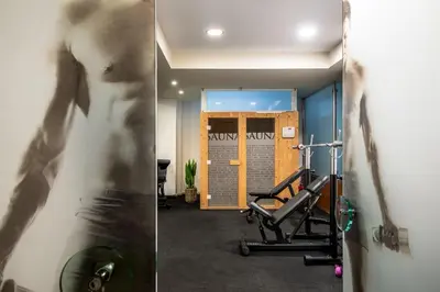 two pictures of a gym with a man and a treadmill at Libyan Princess in Palaiochóra