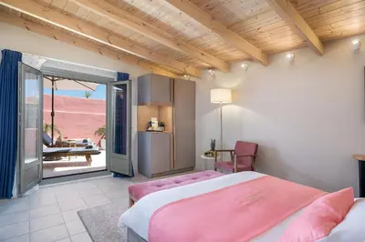 a bedroom with two beds and a view of the desert at Viaggio Elegant Rooms in Chania Town
