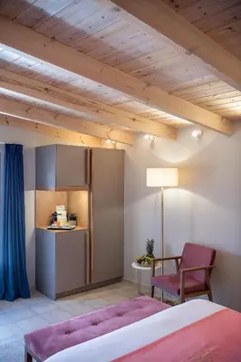 a bedroom with a bed and a table and a chair at Viaggio Elegant Rooms in Chania Town