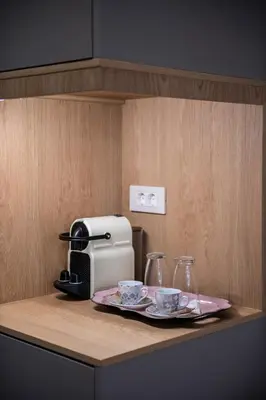 a kitchen counter with a coffee maker and two cups at Viaggio Elegant Rooms in Chania Town