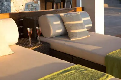 a bed with a pillow and a glass of wine at VILLA TERRA CRETA Luxury Retreat and Spa in Chania Town