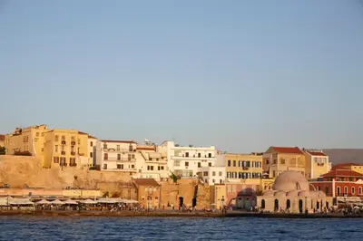 a group of buildings next to the water at La Vita Classica in Chania Town