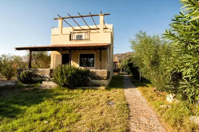 a small house with a window and a balcony at Villas Paleochora in Palaiochóra