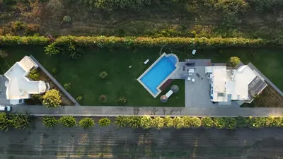 an aerial view of a house with a swimming pool at Oasea in Tavronitis