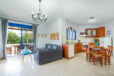 a living room and kitchen with a couch and a table at Oasea in Tavronitis