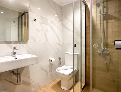 a bathroom with a toilet and a sink and a shower at Akti Galinis in Kalyves
