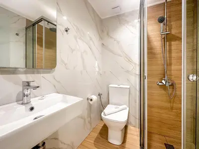 a bathroom with a toilet and a sink and a shower at Akti Galinis in Kalyves