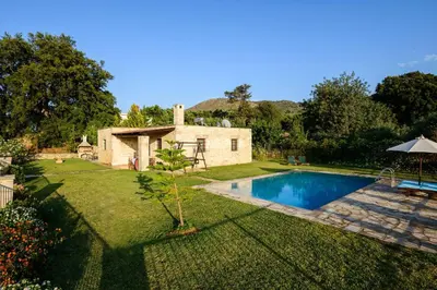 a house with a swimming pool in a yard at Kontis Village in Fílippos