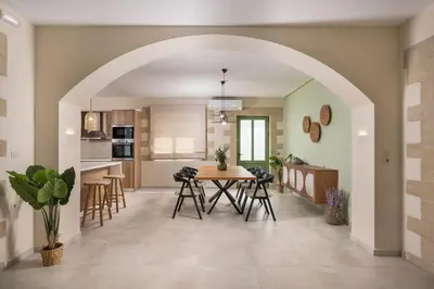 an open kitchen and dining room with a table and chairs at Kontis Village in Fílippos