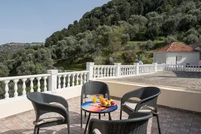 a table with a bowl of fruit on a balcony at Villa Drakona in Keramia