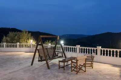 a couple of chairs and a table on a patio at Villa Drakona in Keramia