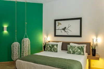 a bedroom with a bed with green walls at Kalamaki Luxury Suites in Kalamaki Chanion