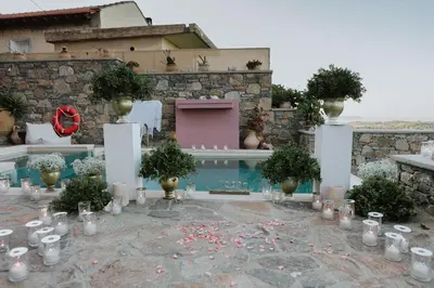 a garden with candles and potted plants in front of a building at Listen to Nature in a Renovated Traditional Hilltop Villa Liodosifis with Heated Pool in Païdhokhórion