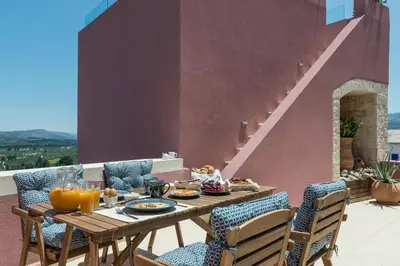 a table with food on it on a patio at Listen to Nature in a Renovated Traditional Hilltop Villa Liodosifis with Heated Pool in Païdhokhórion
