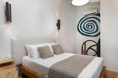 a bedroom with a bed with white sheets and pillows at Kamares Sanctuaries in Kolymvari