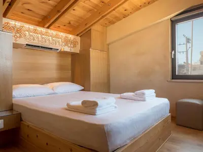 a bedroom with a bed with towels on it at Evans House II in Chania Town