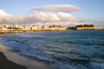 a person swimming in the water at the beach at Evans House II in Chania Town