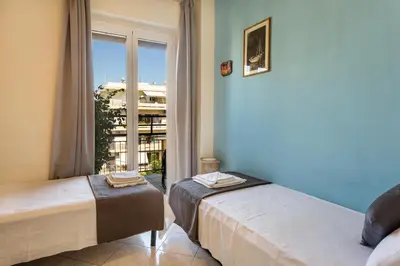two beds in a room with a window at Central luxurious Apartment with sea view! in Chania Town