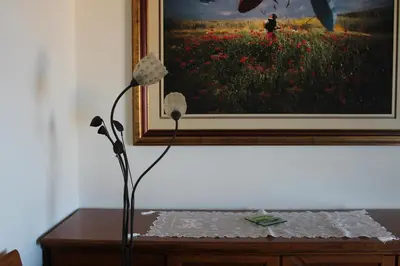 a flower on a table in front of a painting at Central luxurious Apartment with sea view! in Chania Town