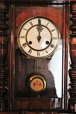 a grandfather clock is hanging on a wall at Central luxurious Apartment with sea view! in Chania Town