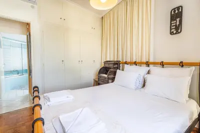a bedroom with a large white bed with white pillows at Central luxurious Apartment with sea view! in Chania Town