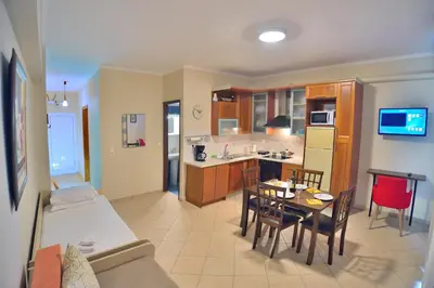 a living room with a kitchen and a dining room at Beach House in Kissamos